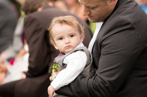 Sitting on Eric's lap paying attention to the photographers... i mean ceremony... 