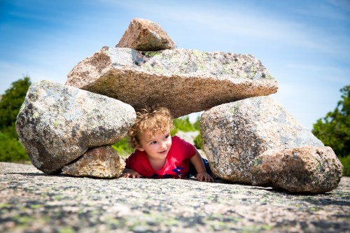 Crawling under a cairn (trail marker)