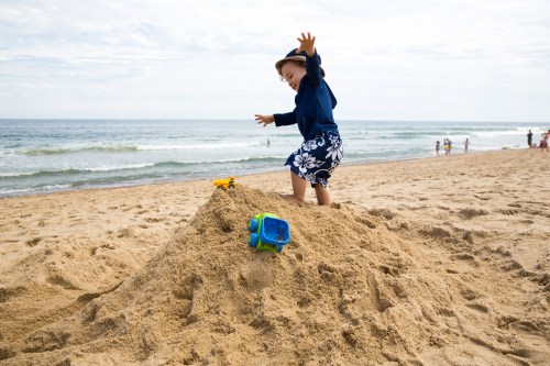 Climbing his sand castle