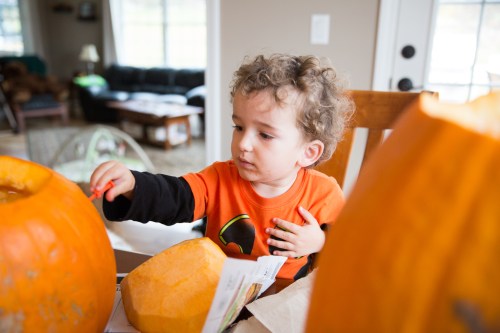 Cam helping to carve the pumpkin for Halloween